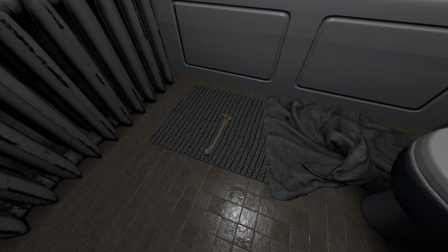 Phasmophobia: a bone lying on the floor in a bathroom.