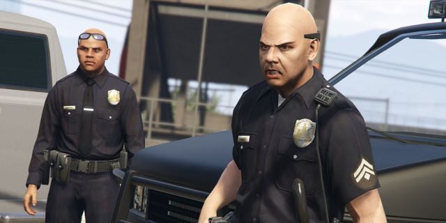 Two police officers standing in front of a cop car in GTA V.