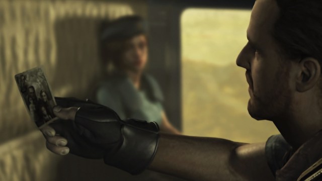 Resident Evil remake: Barry Burton looking quizzically at a photo while Jill Valentine sits in the distance.