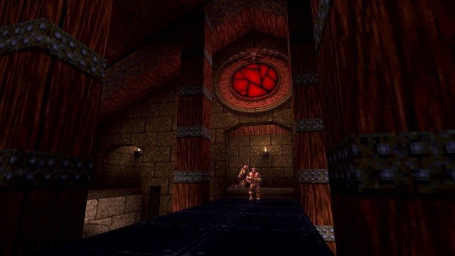 Quake: a couple of enemies stand at the end of a dark bridge.