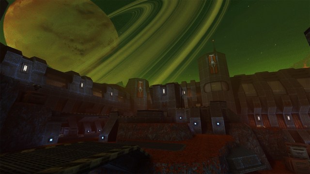 Quake 2: the remaster , showing a huge and gray military style complex, and a giant, ringed planet looming in the sky.