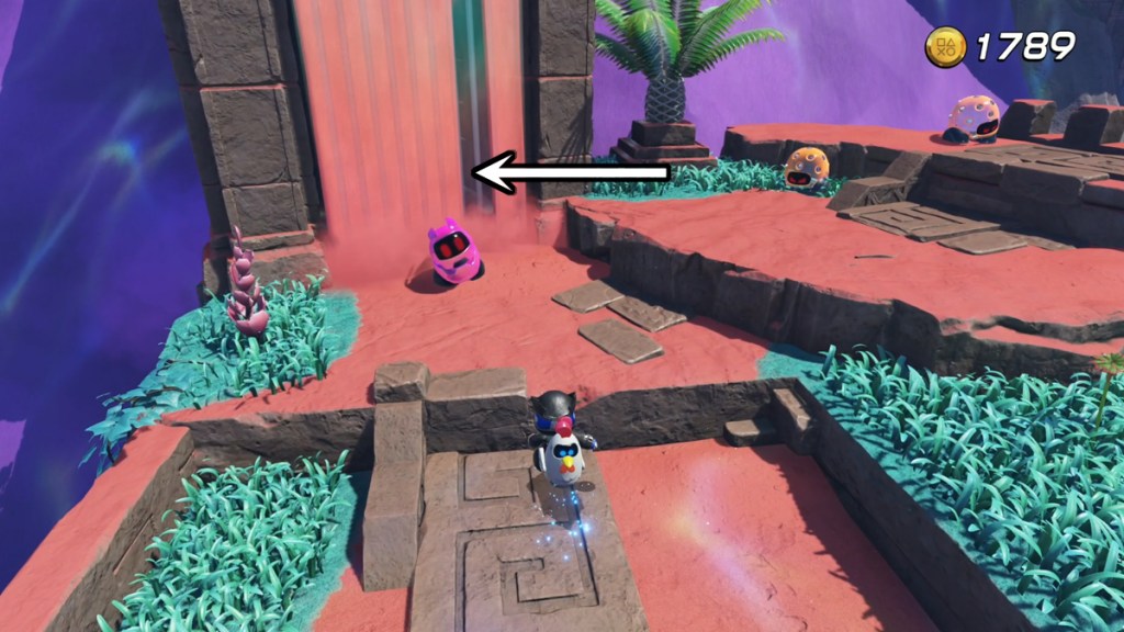 Astro Bot approaching an enemy with an arrow pointing to a captive bot.