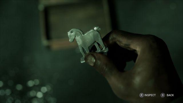 Sam Green holding the Wooden Horse Trinket in the storm drain.