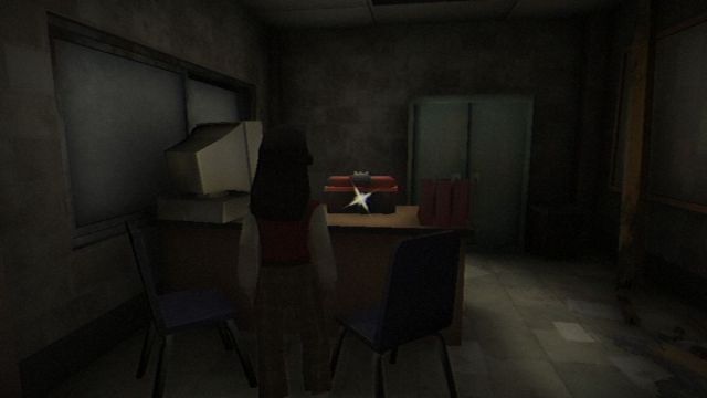 Vivian standing near a locked toolbox on the desk in the office.