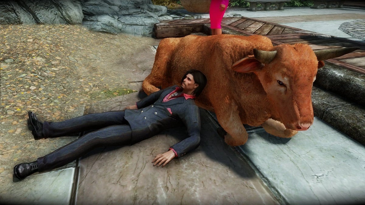 Skyrim: a man rests against a cow that's lying down by some stone steps.